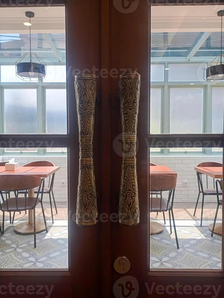 photo of a brass door handle with carvings