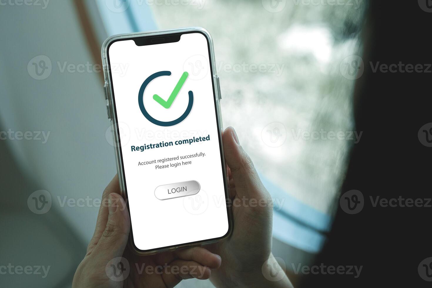 Smartphone screen shows Registration completed with Log in to proceed to the next step. The technological concept of project registration or membership application. photo