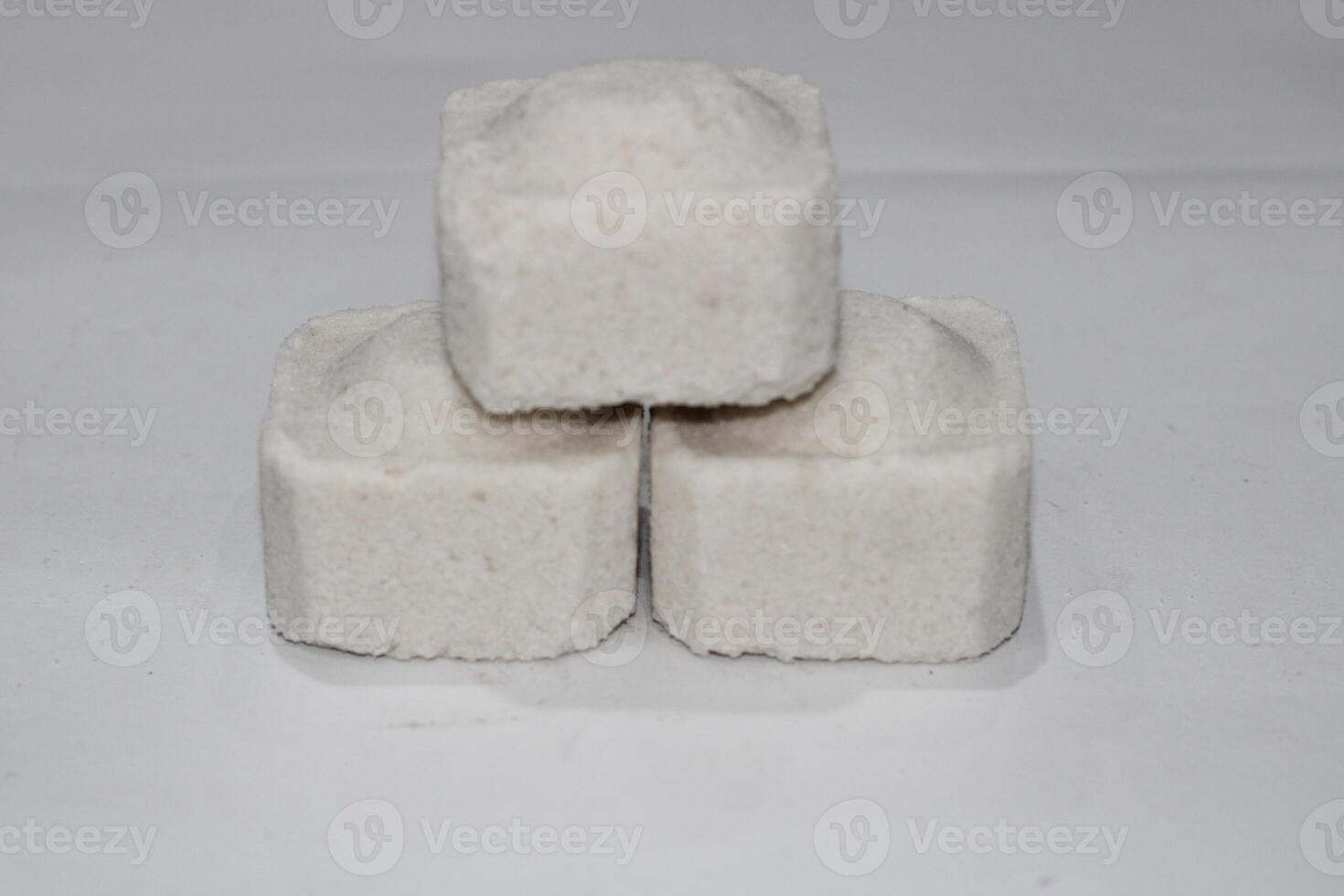 Three white square shaped objects stacked on a white background. photo