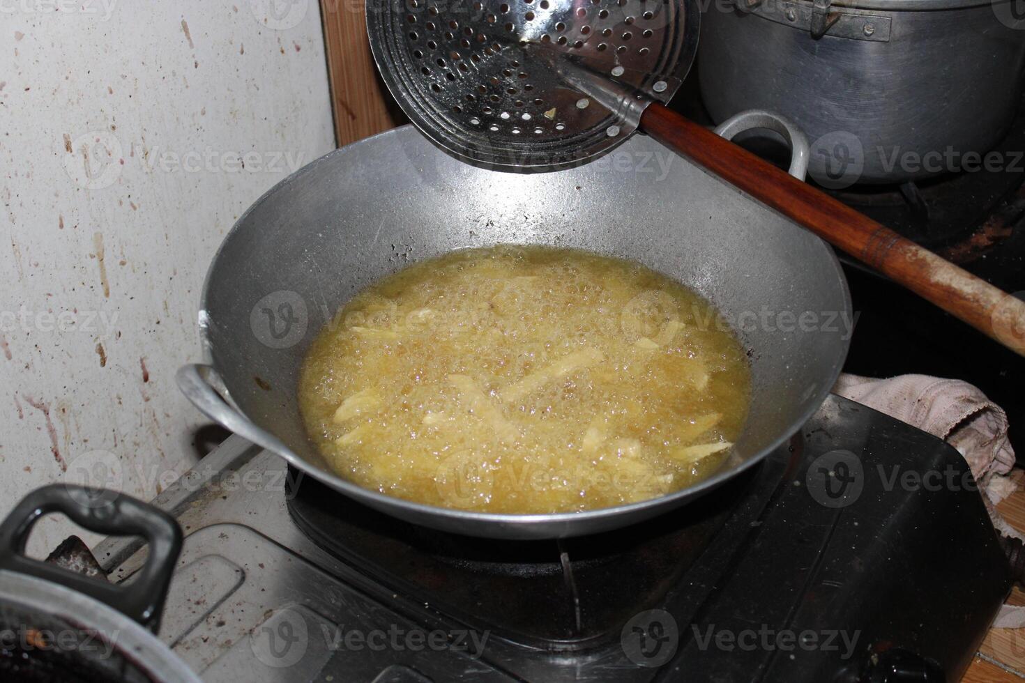 Food being deep fried in a pan. photo