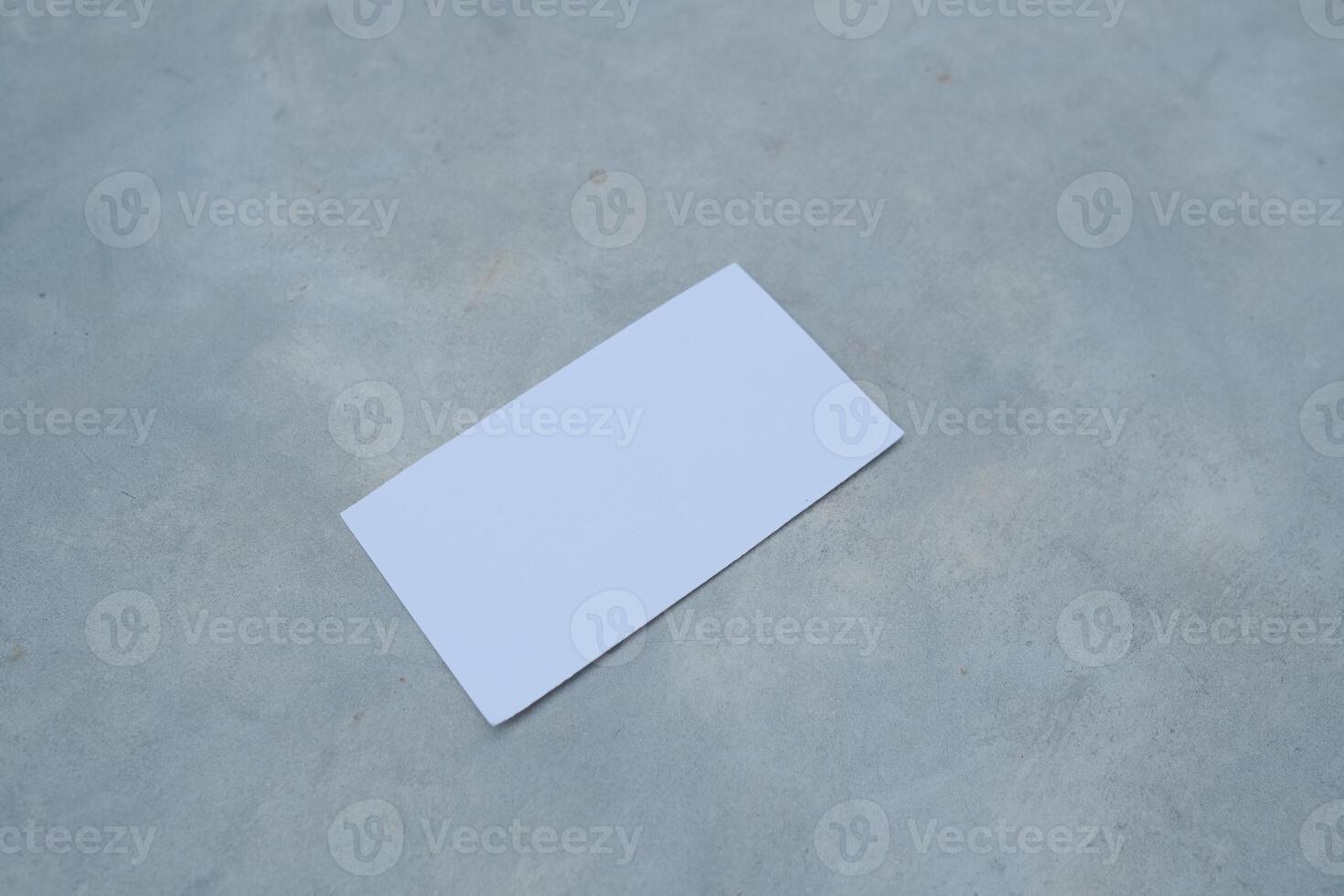 White blank card on a gray surface. photo