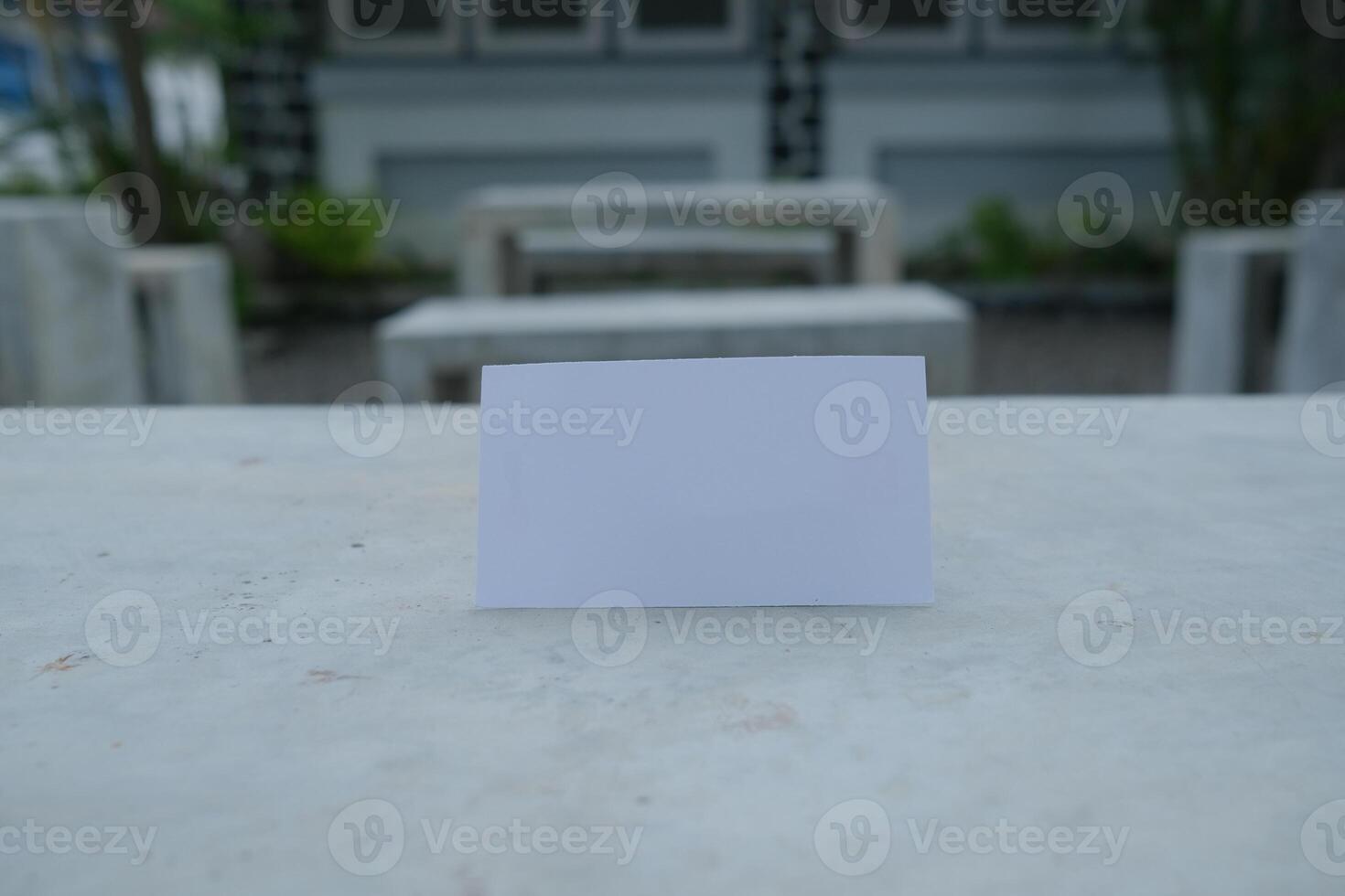 Blank white card on a concrete surface. photo