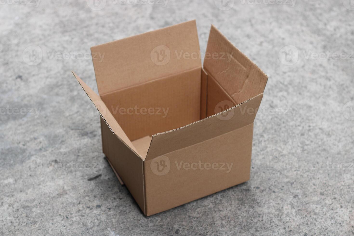 Empty cardboard box on a concrete surface. photo