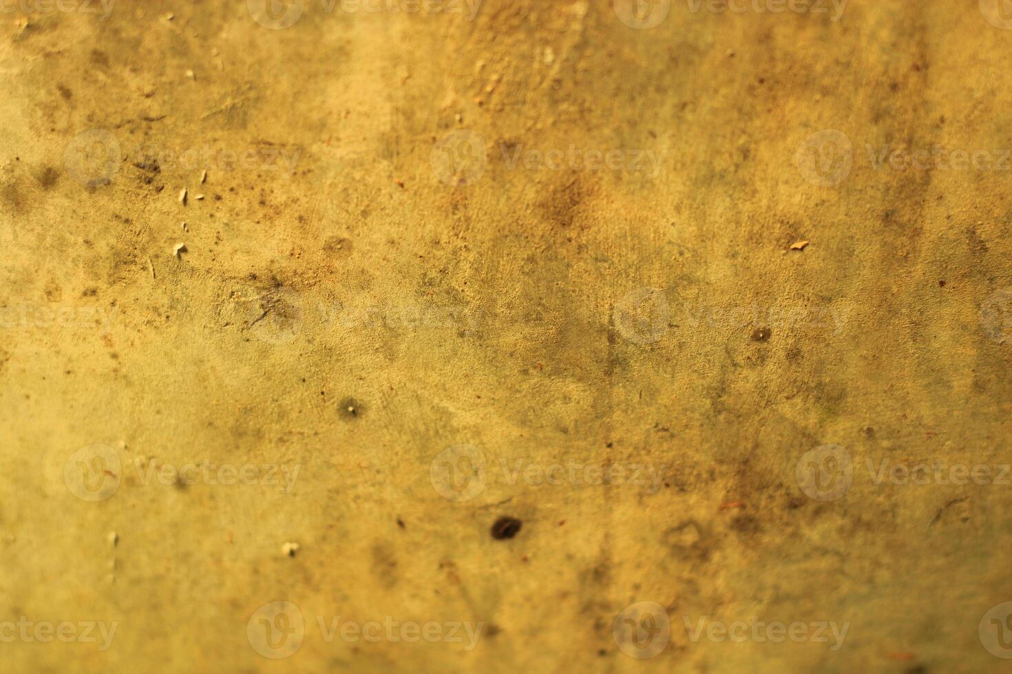Close-up of a textured, weathered, yellow surface. photo