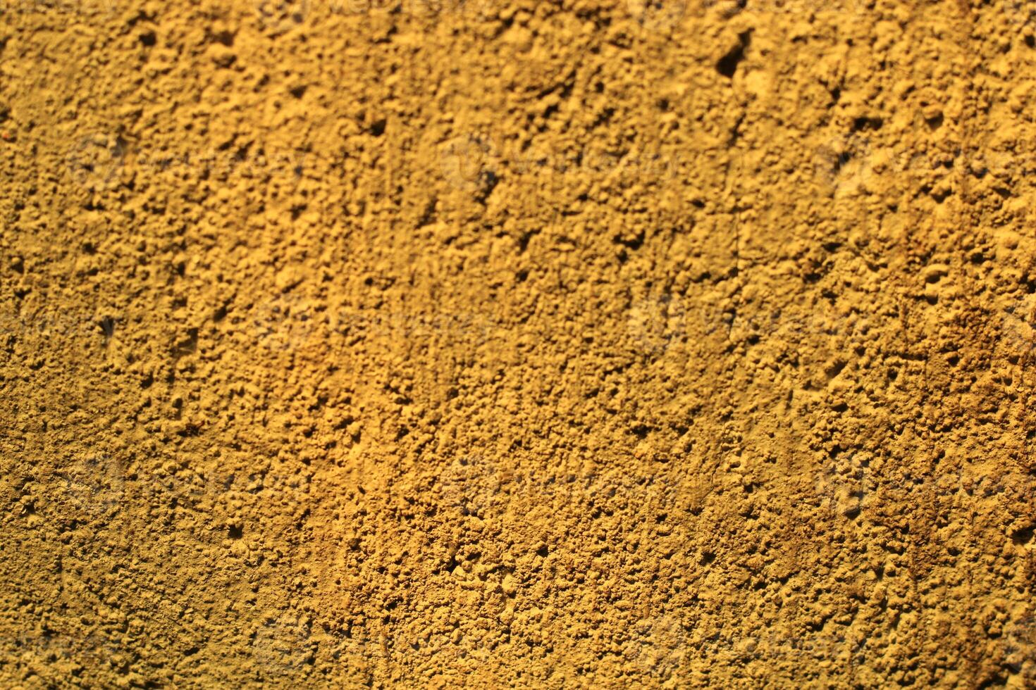 Close-up of a textured yellow wall. photo