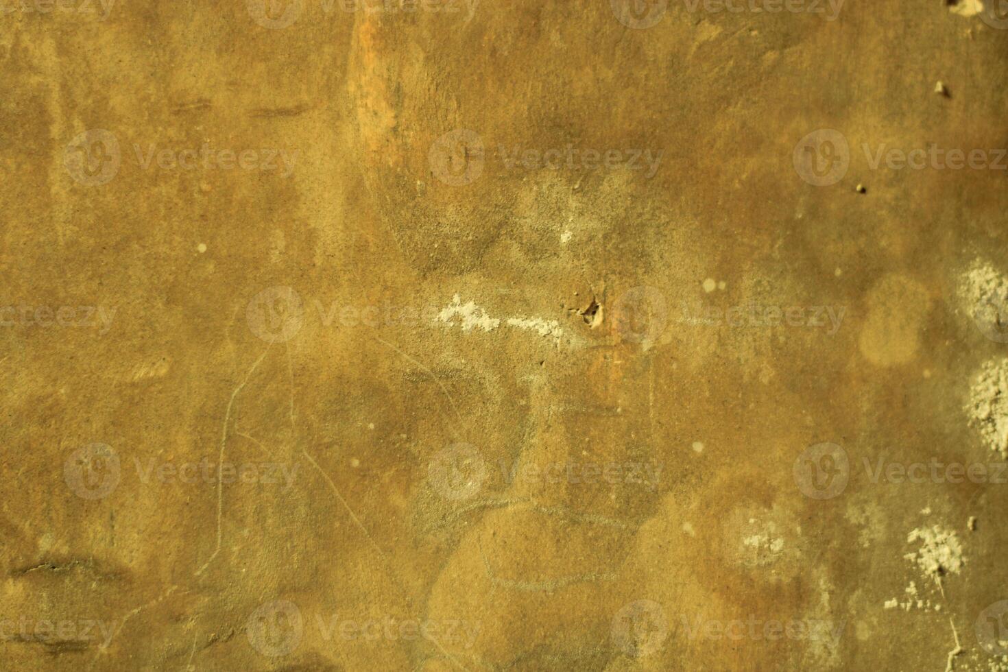 Close-up of textured yellow wall with white blotches. photo