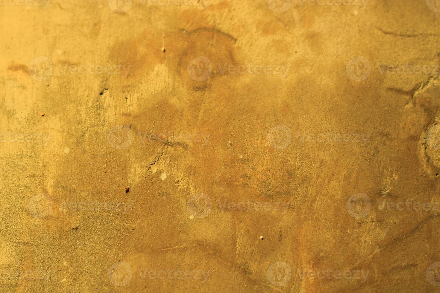 Rough, textured golden surface with subtle variations. photo