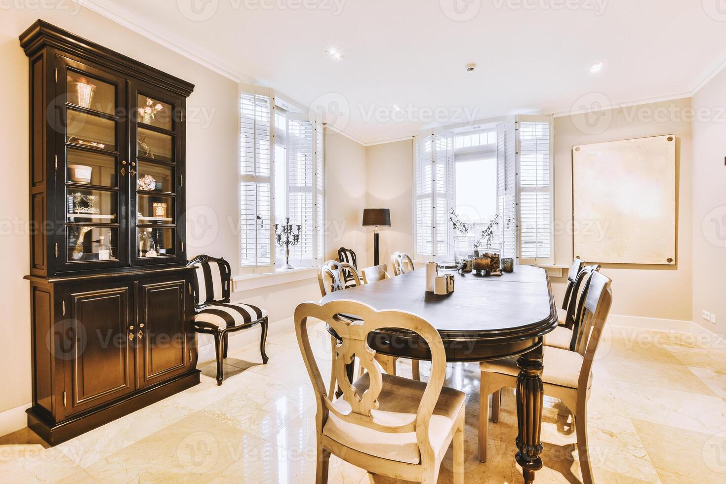 A dining room with a table and chairs photo