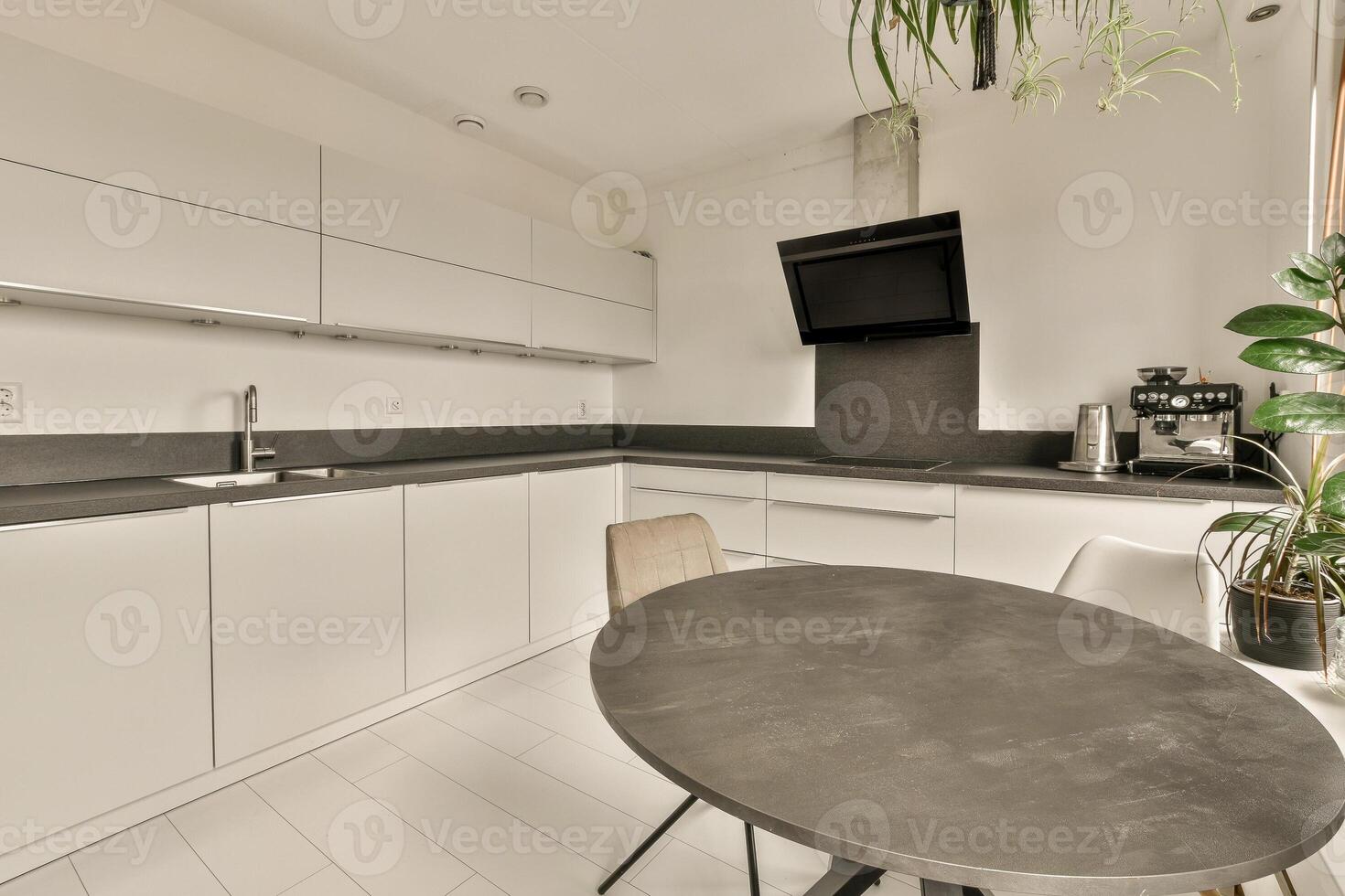A kitchen with a table and chairs in it photo