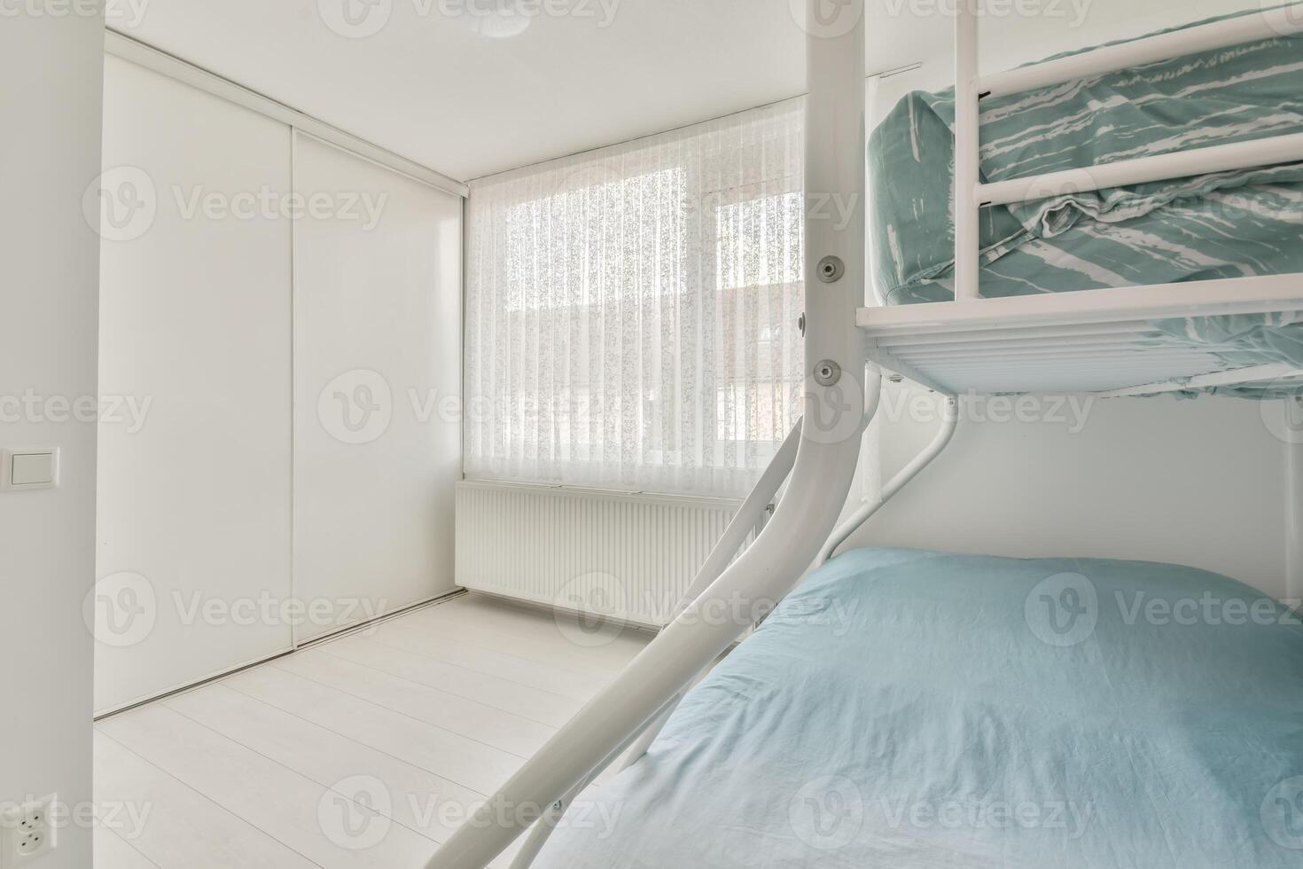 A bedroom with two bunk beds and a window photo