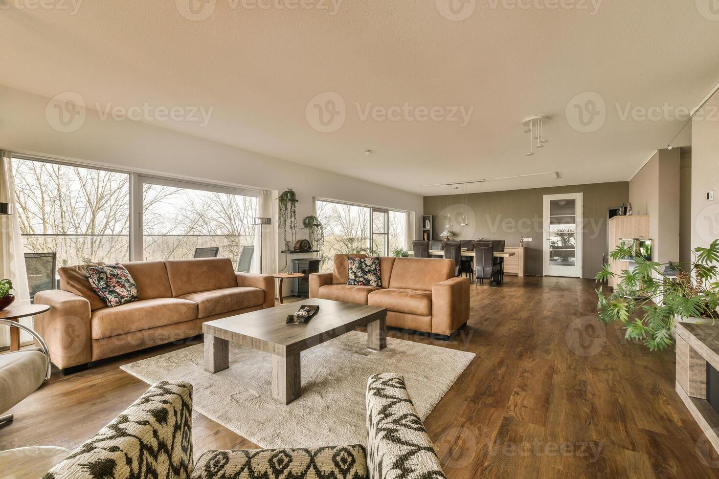 A living room with a couch, chair, coffee table and a window photo