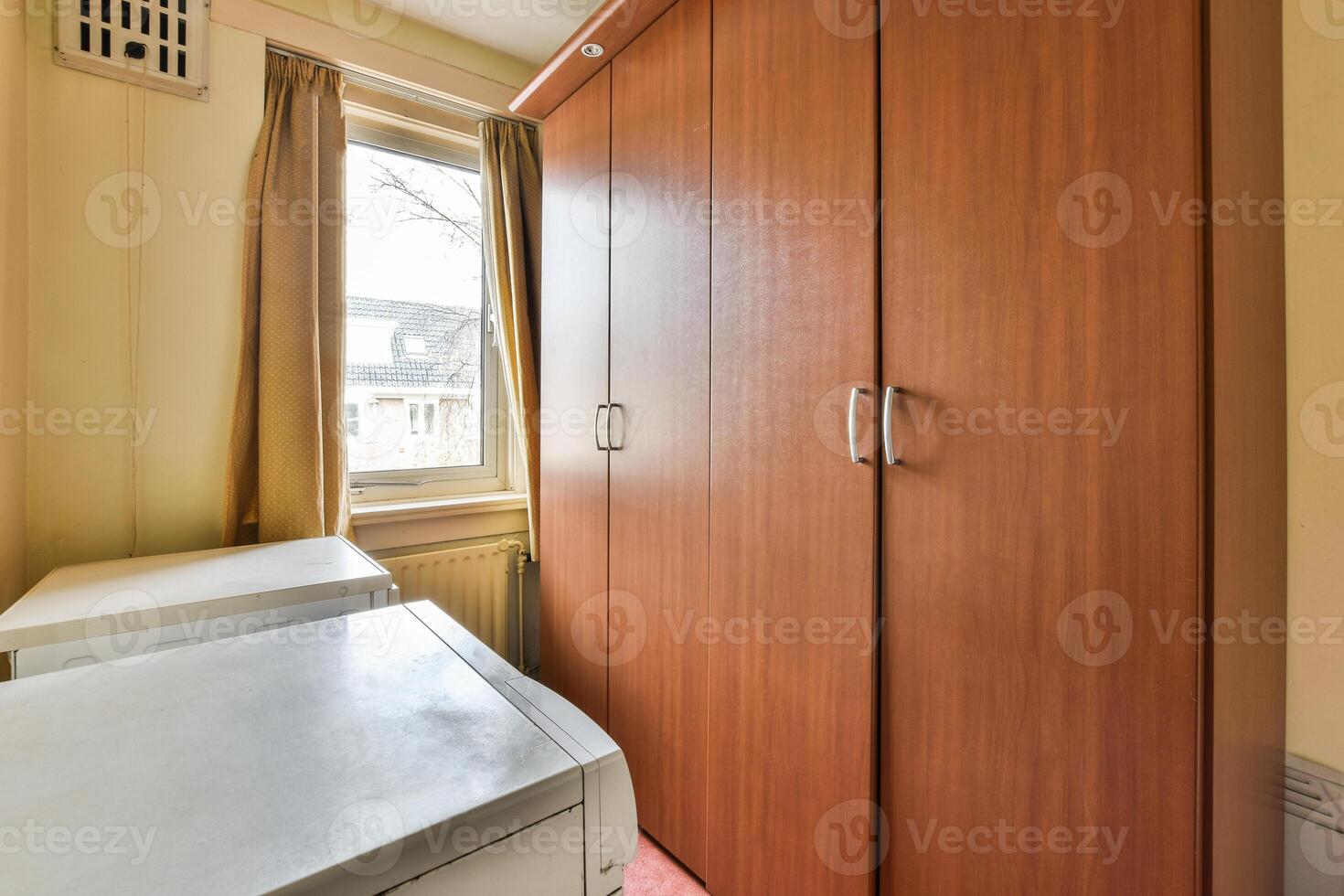 A small room with a washer and dryer photo