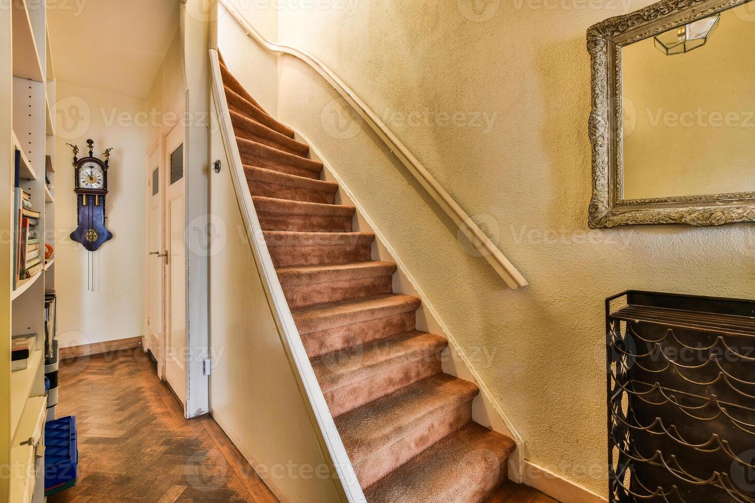 A staircase leading up to a room with a clock photo