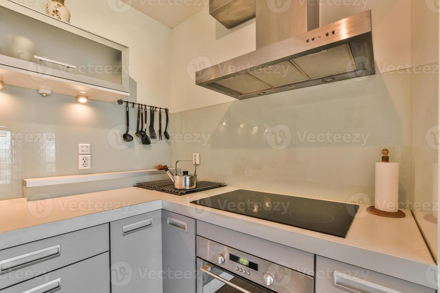 A kitchen with a stove and oven photo