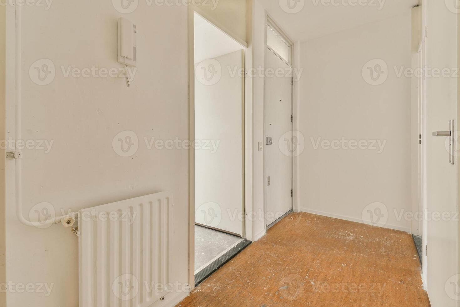 A hallway with a radiator and a door photo