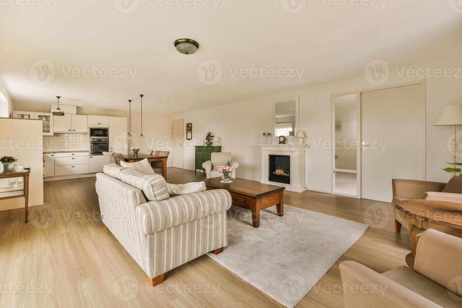 A living room with a couch, chair, table and fireplace photo