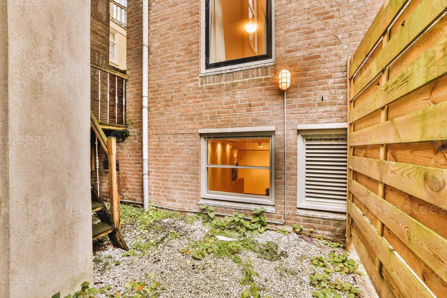 A small building with a ladder and a window photo
