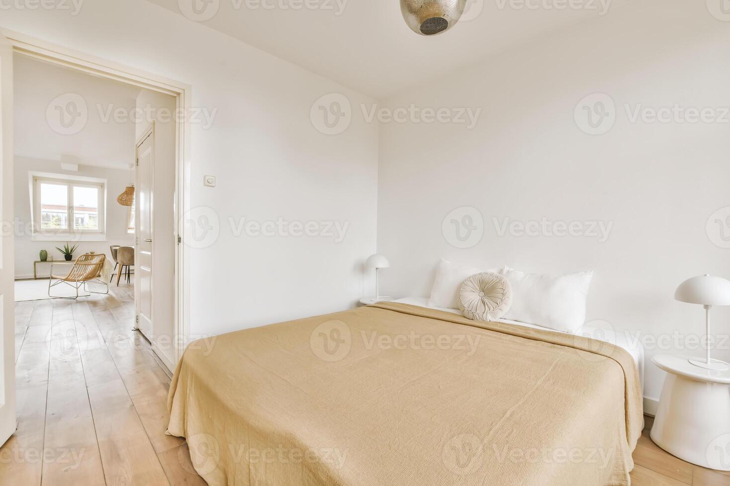 A bedroom with a white bed and wooden floors photo