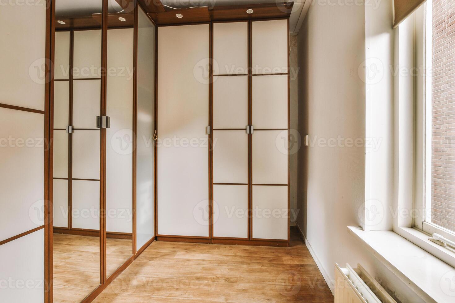 A room with a wooden floor and white walls photo