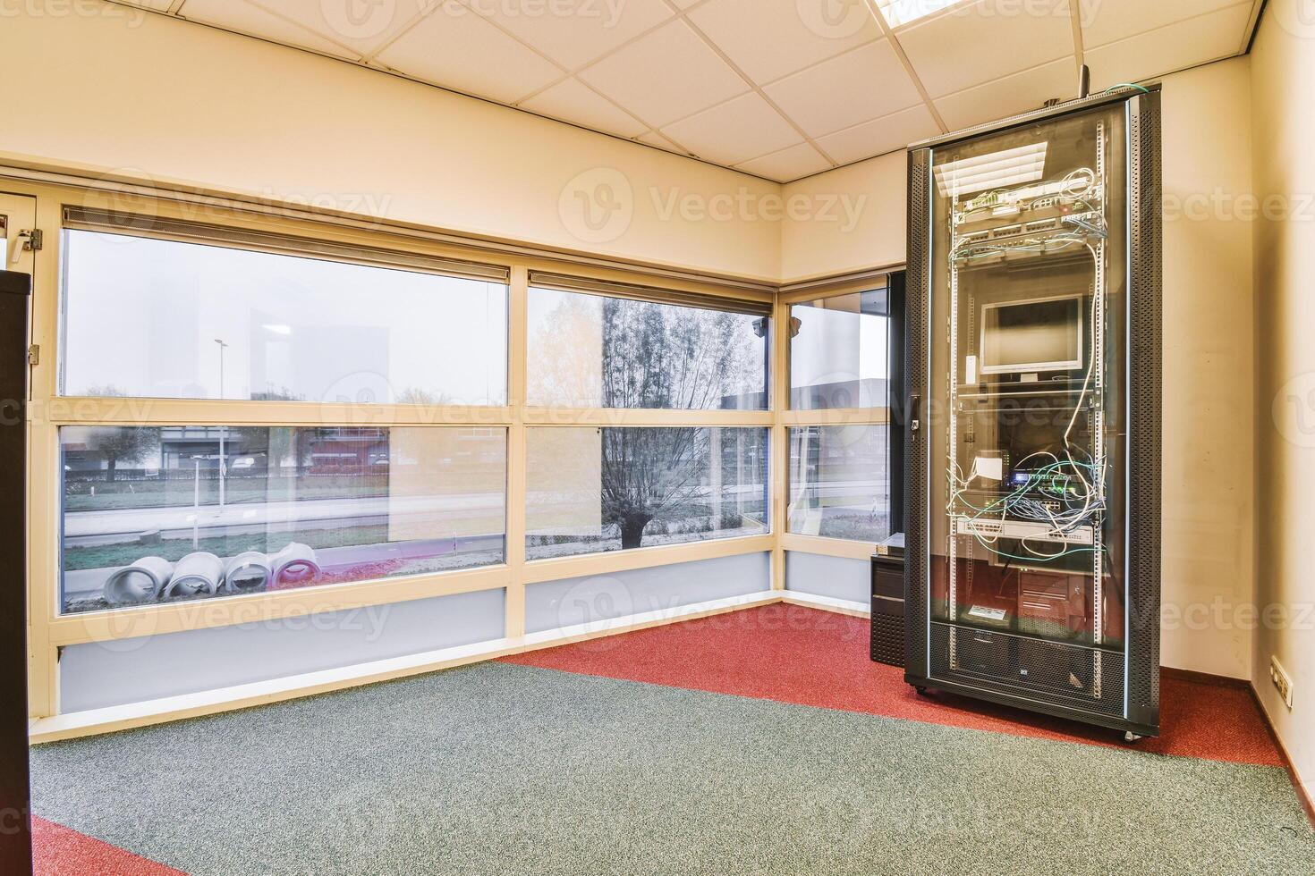 A room with a large window and a computer in it photo