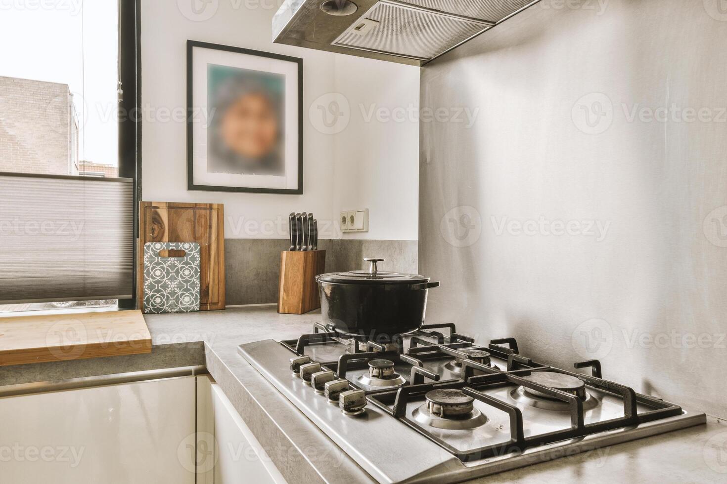 A kitchen with a stove and a window photo
