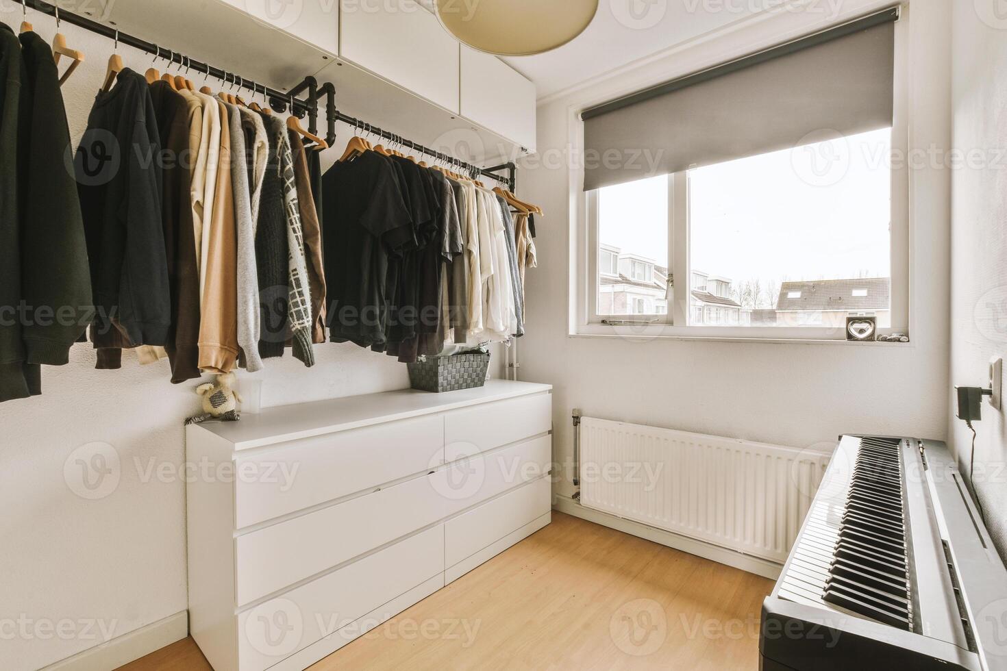 A closet with clothes and a piano photo