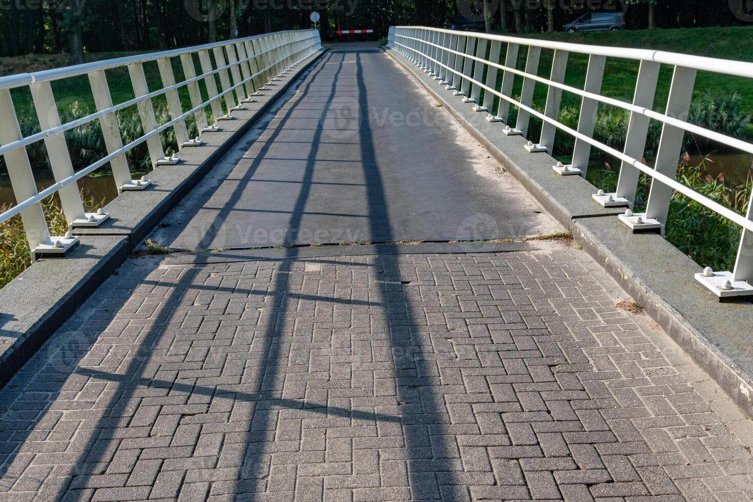 narrow canal bridge with white railing photo
