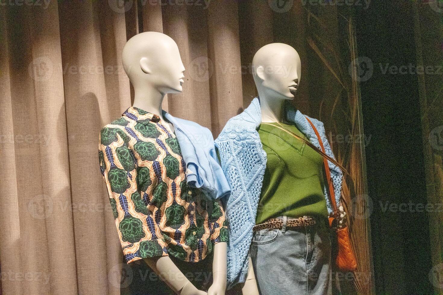 mannequin in a shop window at night photo