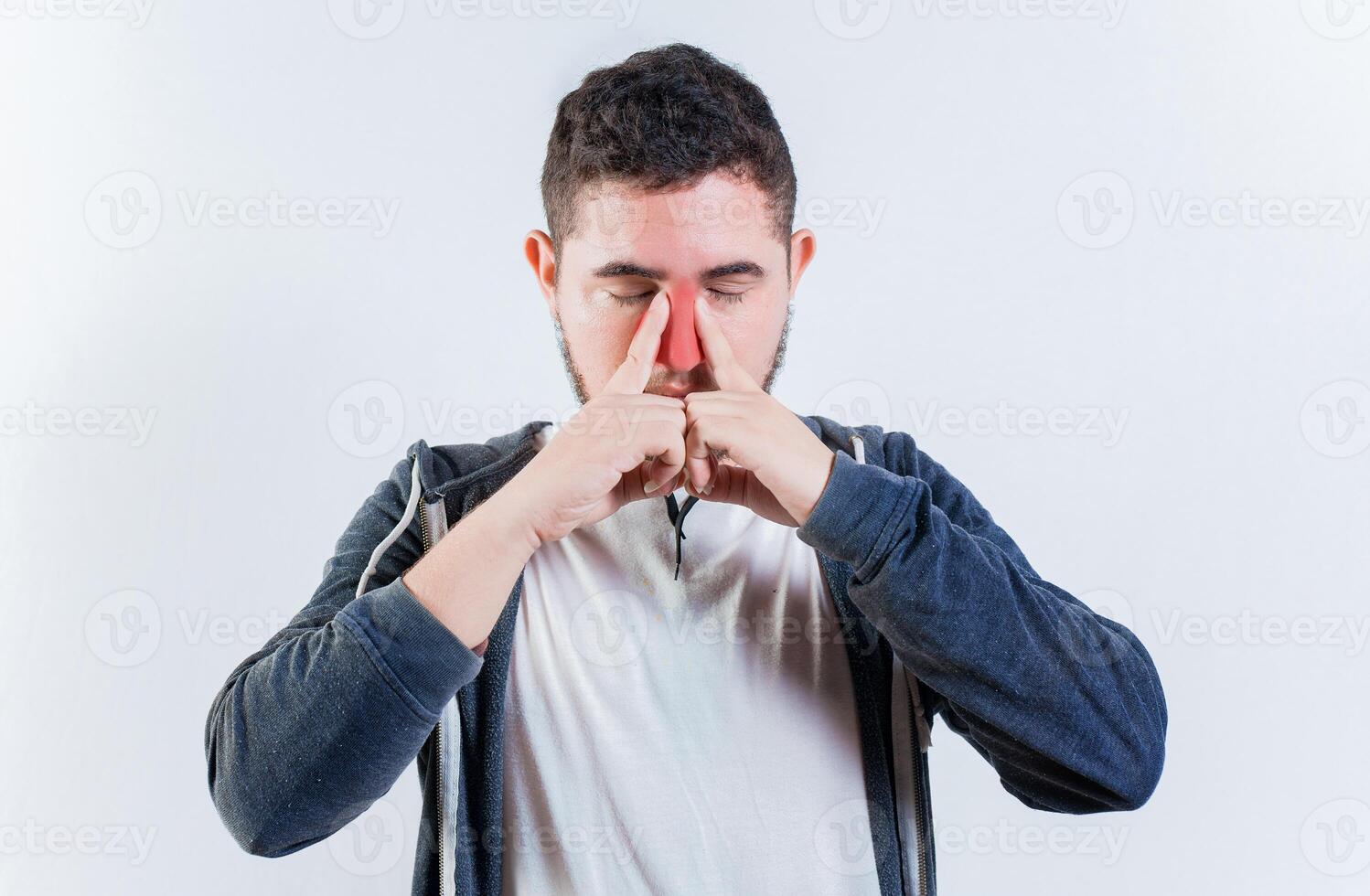 Suffering man with nasal congestion isolated. Sore person suffering with nasal bridge on isolated background photo