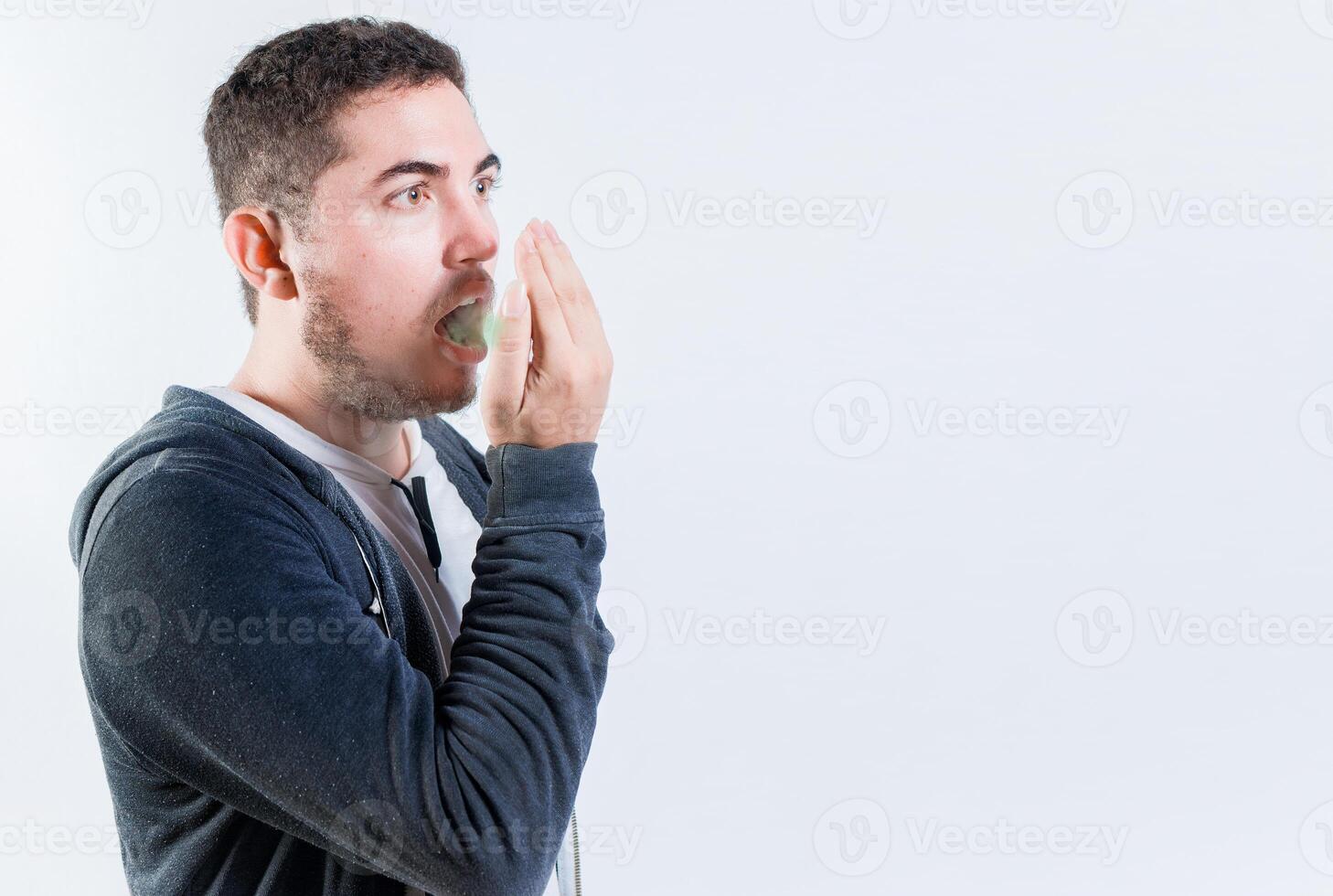Person with bad breath problem isolated. Man with latisosis checking bad breath photo