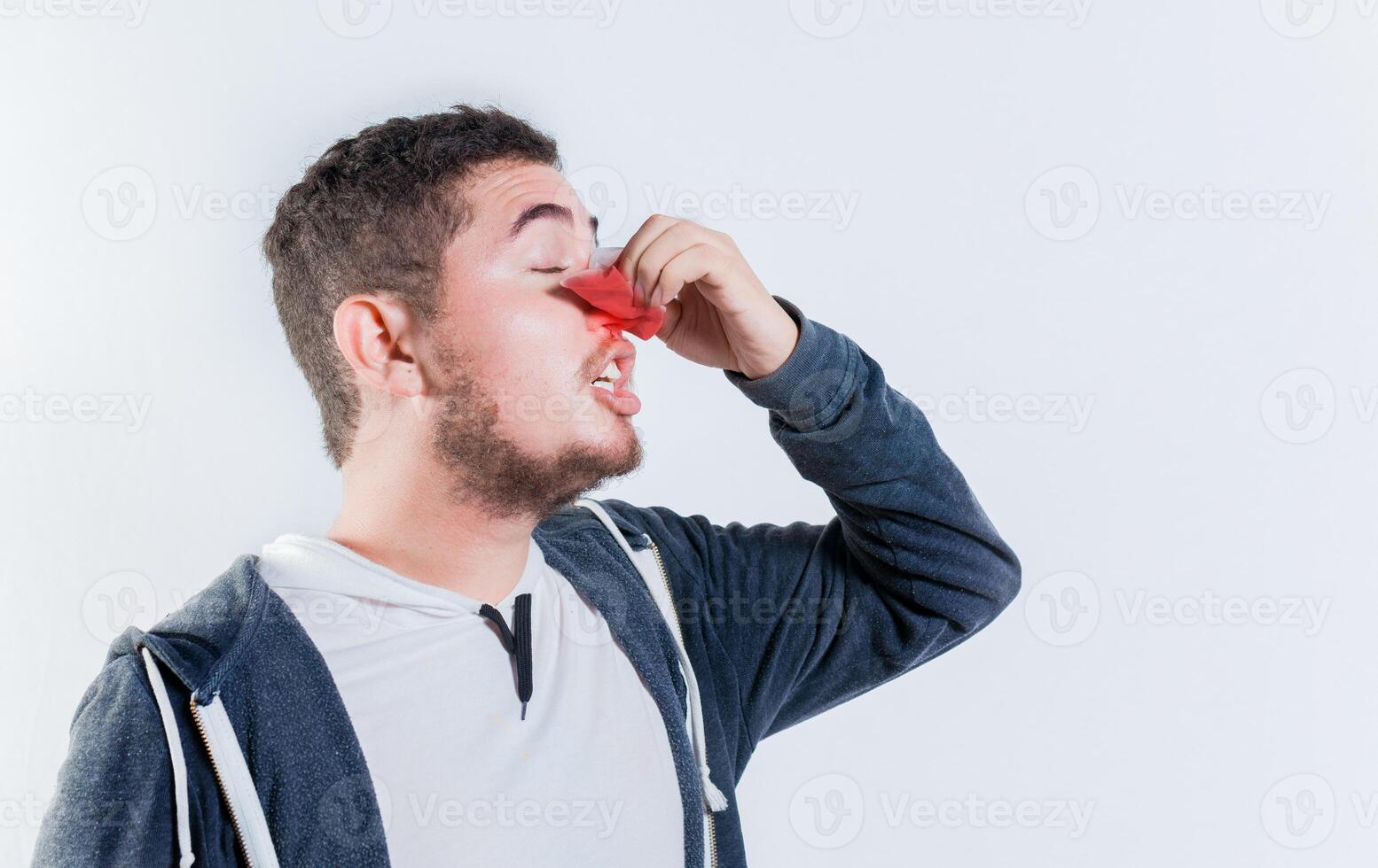 Person with nosebleed isolated. Concept of nasal congestion photo