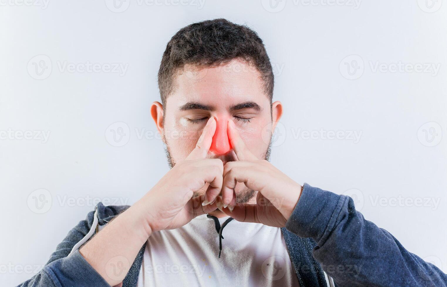 Sore person suffering with nasal bridge on isolated background. Suffering man with nasal congestion photo
