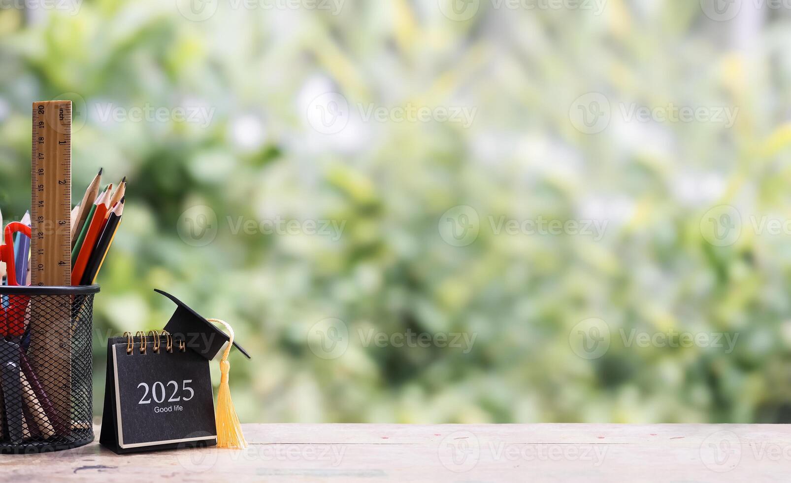 Student creative desktop, colorful stationery and 2025 desk calendar with graduation hat. Copy space for text, Back to school, Education concept photo