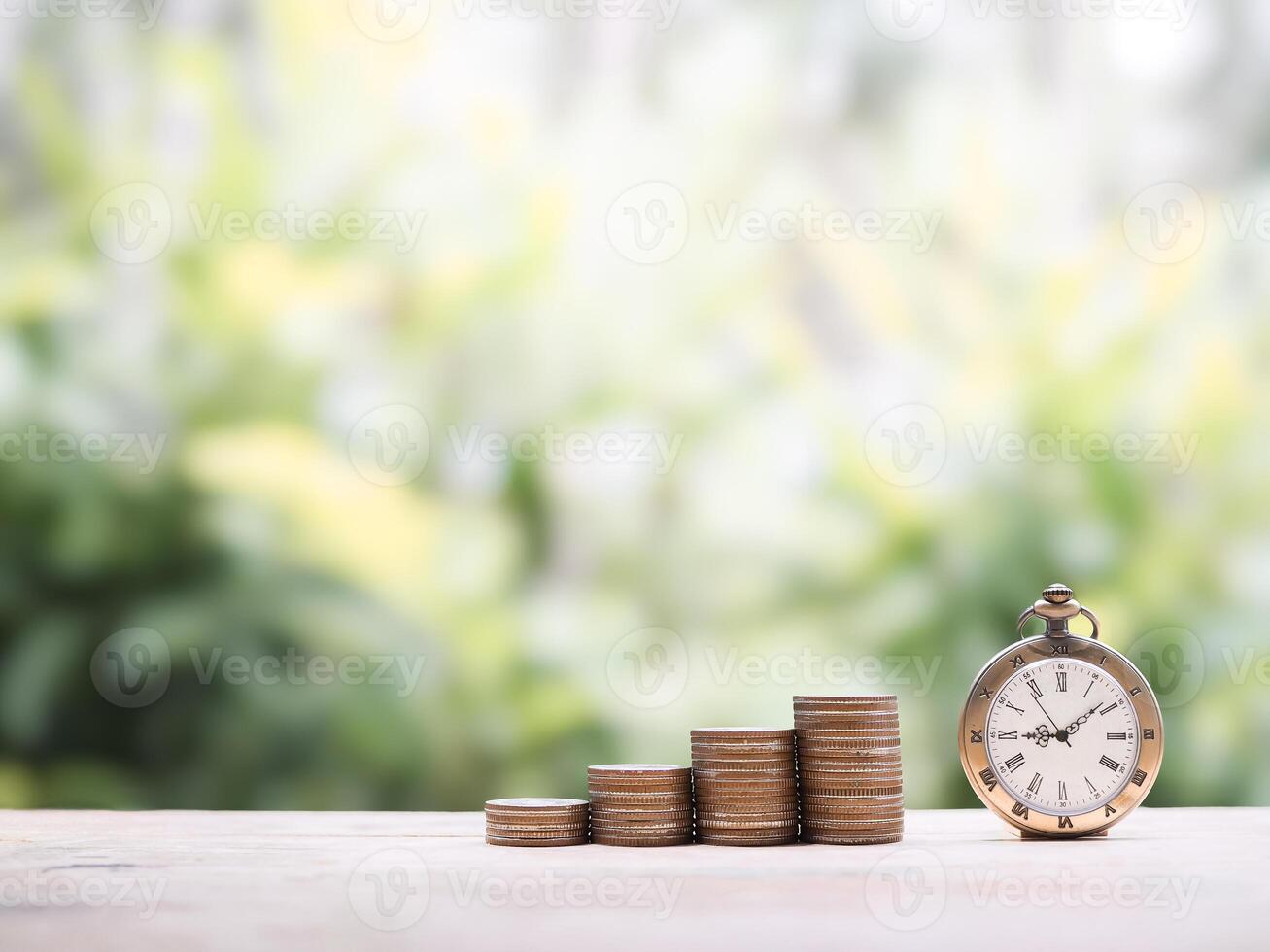 Vintage watch and stack of coins. The concept of saving money for manage time to success business. photo
