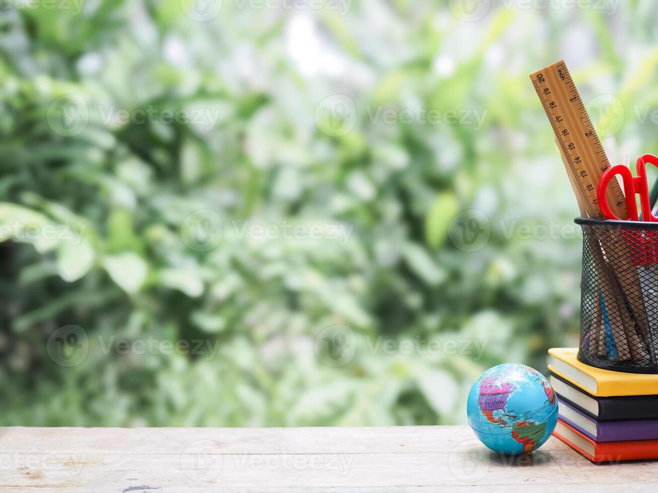 Student creative desktop with colorful stationery on hardcover book and earth globe. Copy space for text, Back to school, Education concept photo