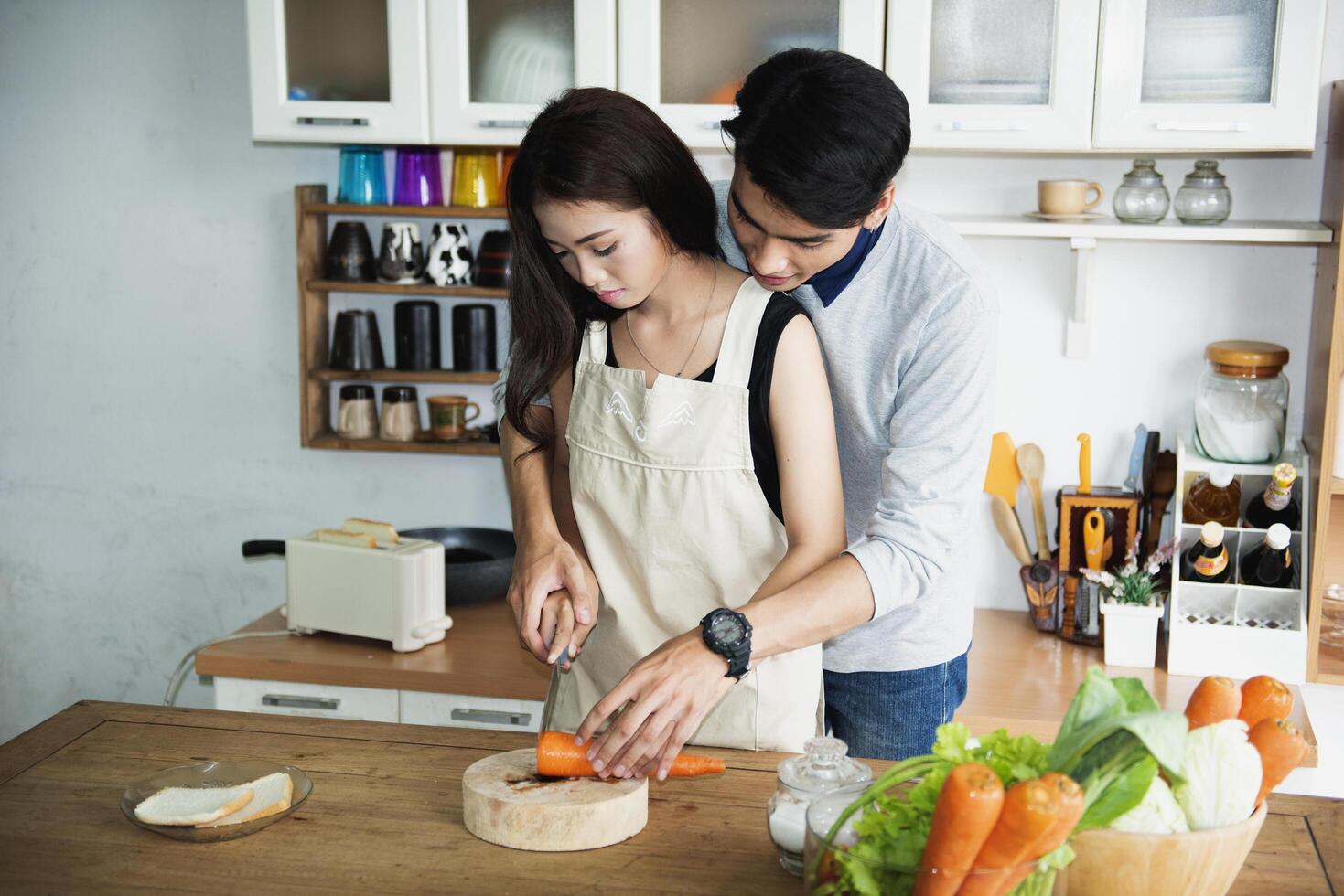 A happy family cooking together in a bright kitchen shows their happiness, teamwork, and love for home-cooked food, creating a warm and loving atmosphere at home. photo