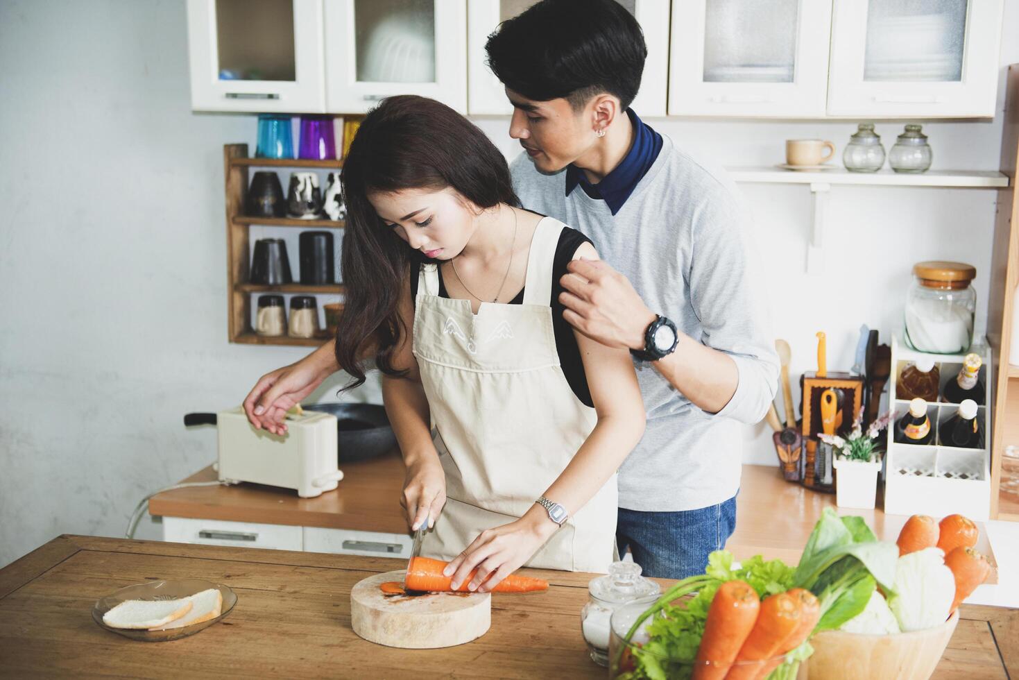 A happy family cooking together in a bright kitchen shows their happiness, teamwork, and love for home-cooked food, creating a warm and loving atmosphere at home. photo