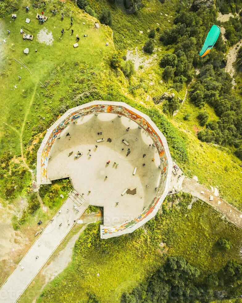 Kazbegi, Georgia - 8th september, 2024- aerial top down view tourist visit famous landmark, Russia Georgia Friendship Monument or Treaty of Georgievsk Monument photo