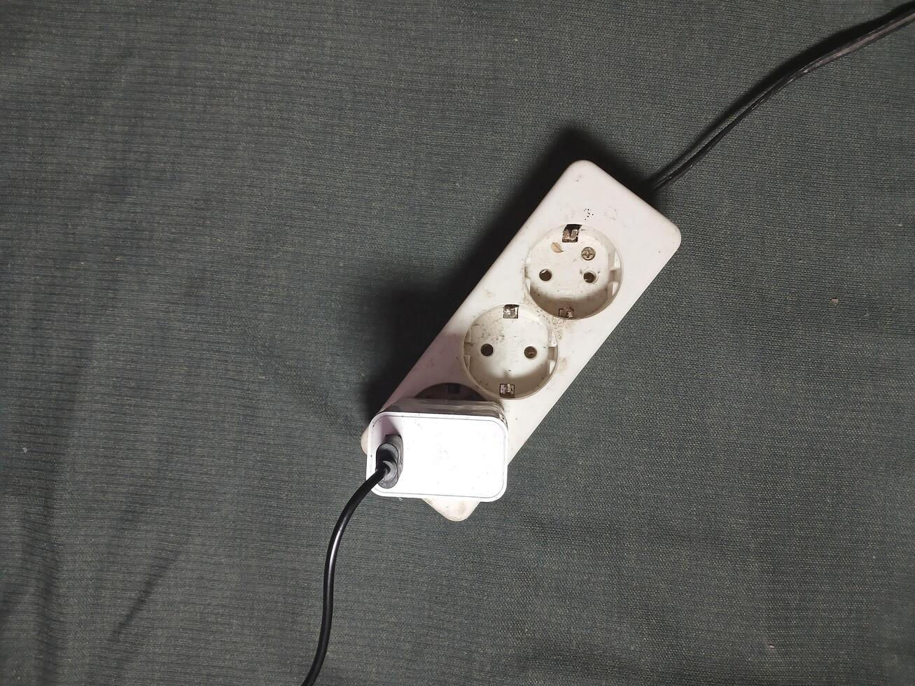 White electrical plug in wall socket. photo