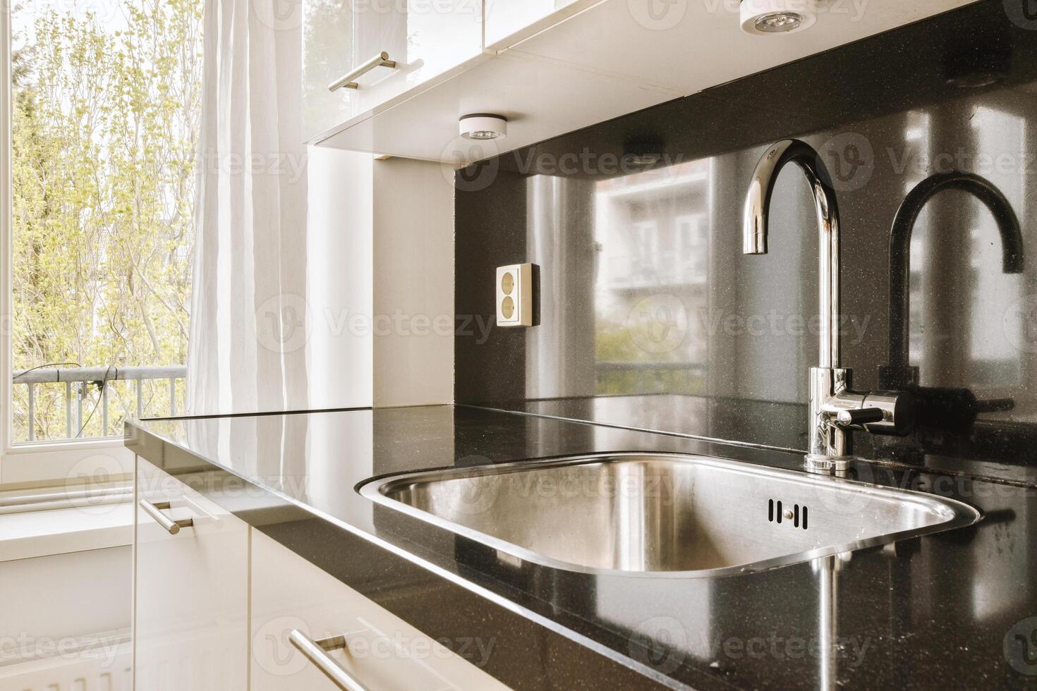 A kitchen with a sink and a window photo