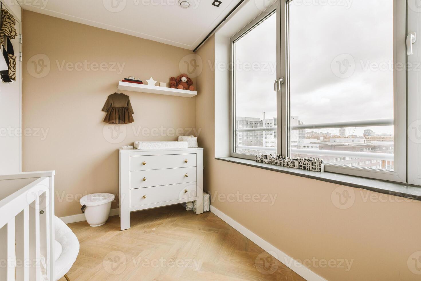 A small room with a white dresser and a window photo