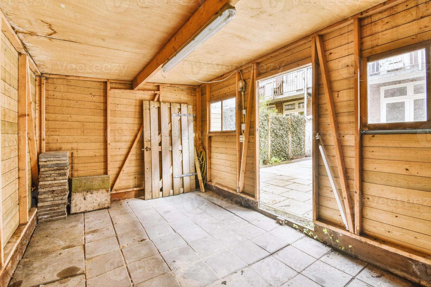 An empty room with wooden walls and a door photo