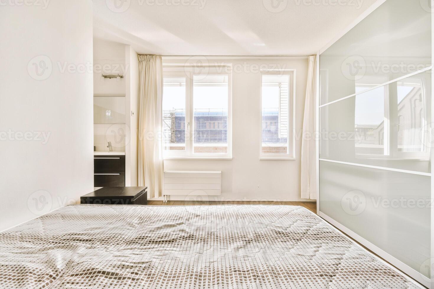 A bedroom with a bed and a closet photo