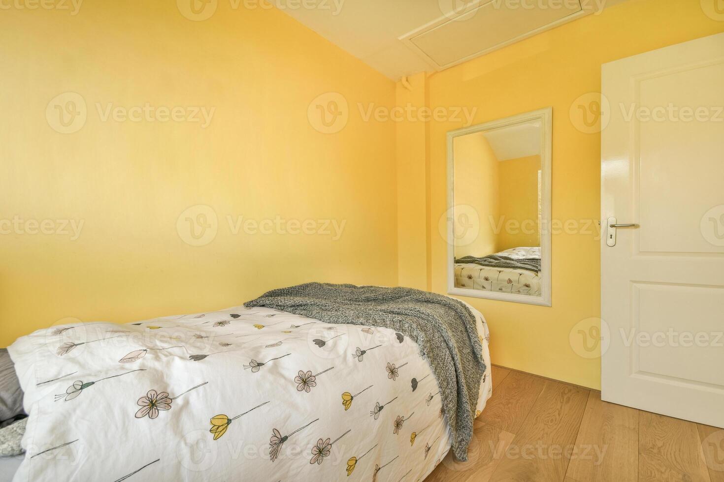 A bedroom with yellow walls and a bed photo