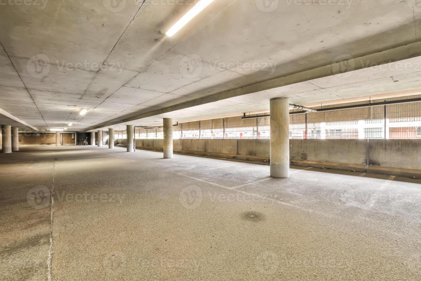 An empty parking garage with concrete floors photo