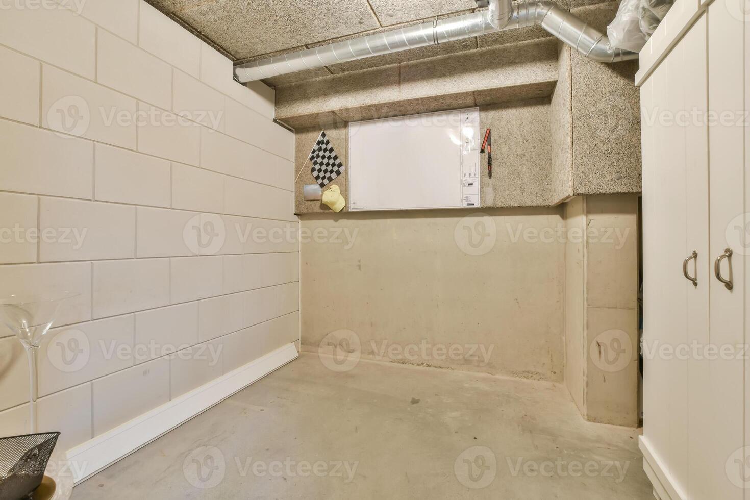 A bathroom with a shower and toilet in a basement photo