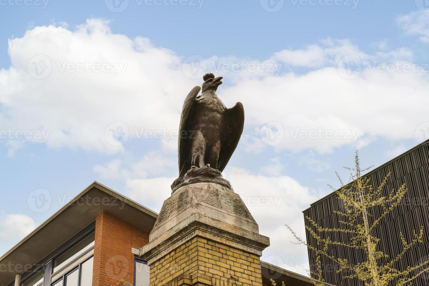 A statue of a bird on a pole photo