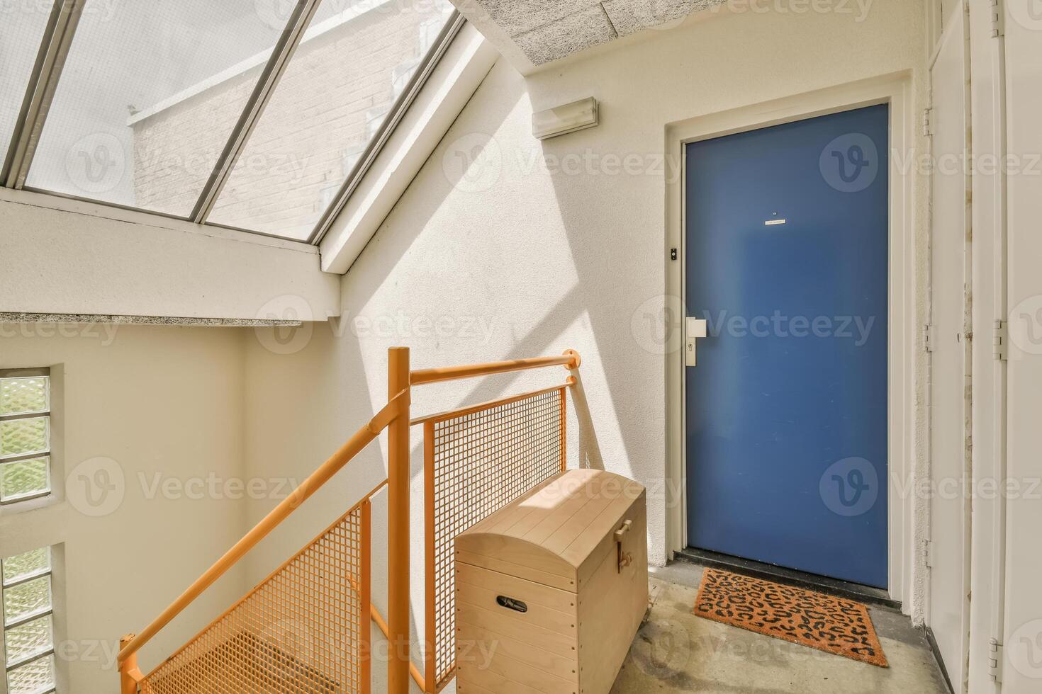 An open door with a blue door and a stairway photo