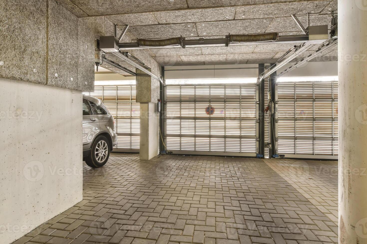 A car is parked in a garage with a door open photo