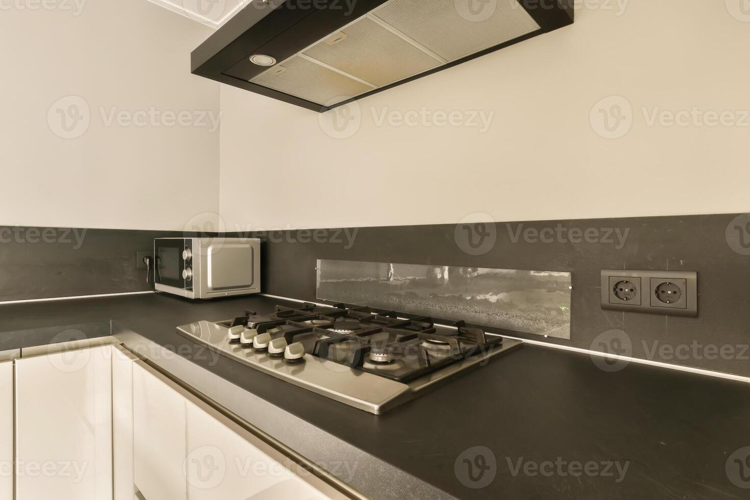 A kitchen with a stove and microwave photo